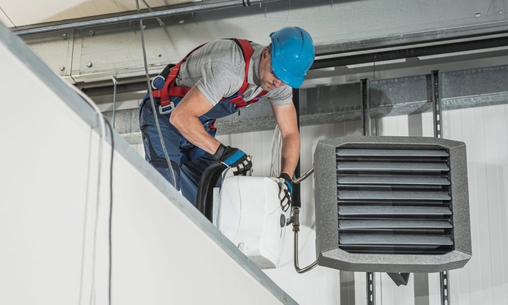 hvac-technician-installing-new-warehouse-air-water-heaters-scaled.jpg