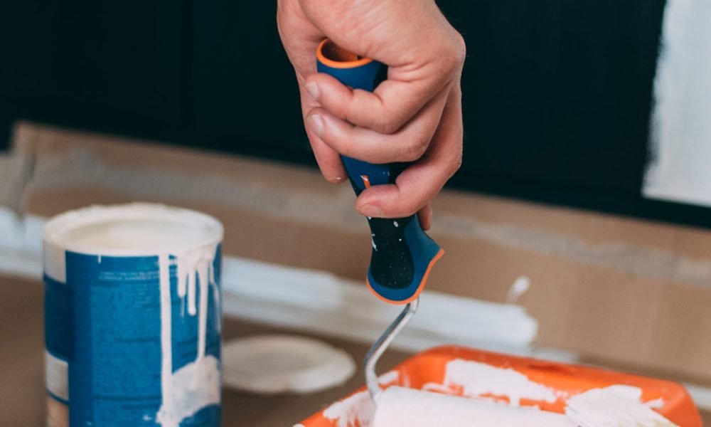 Man hands painting with a roller